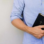 bible in the hands of a guy