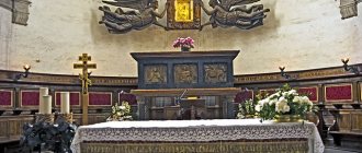 Behind the Catholic throne on a dais is the tomb of St. Luke the Evangelist